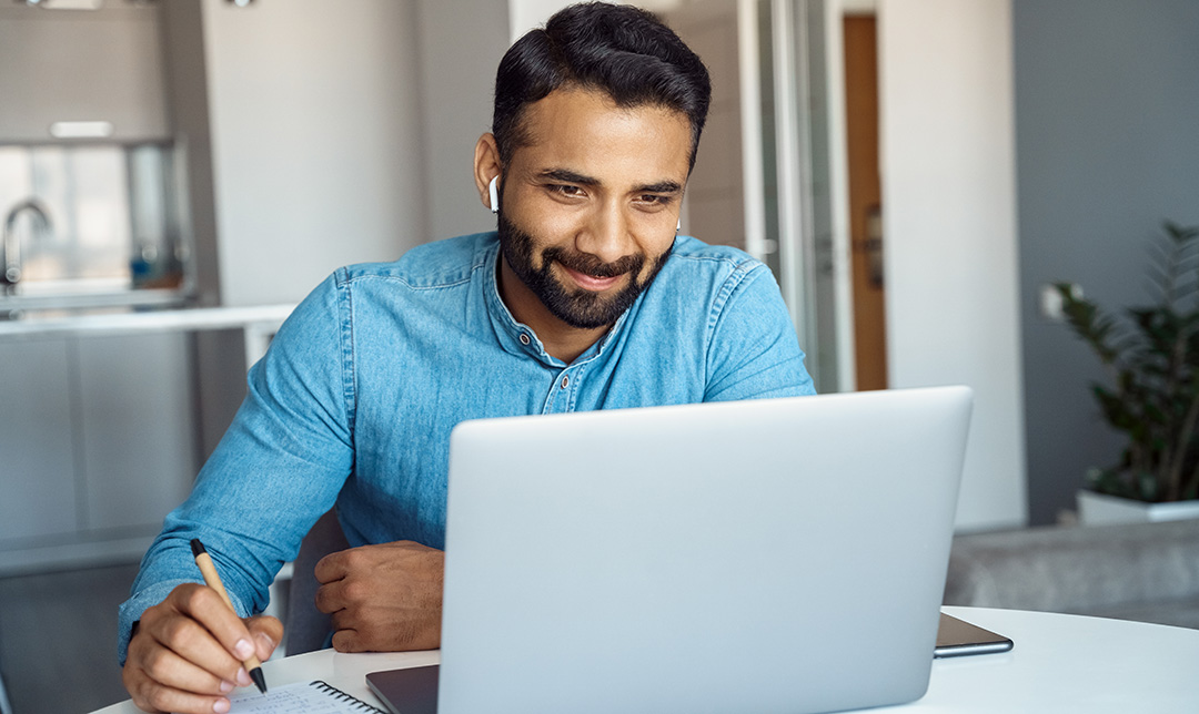 Person working on a laptop at a desk