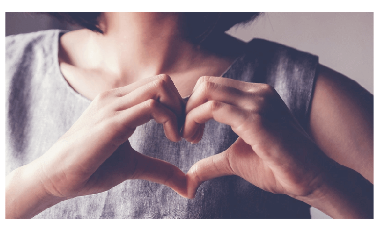 photo of someone making a heart shape with their hands