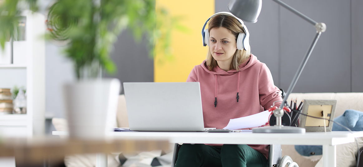 Female working at her desk wearing large headphones