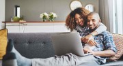 Couple sitting in front of laptop