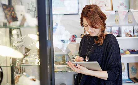 Photo of woman in a shop using an iPad