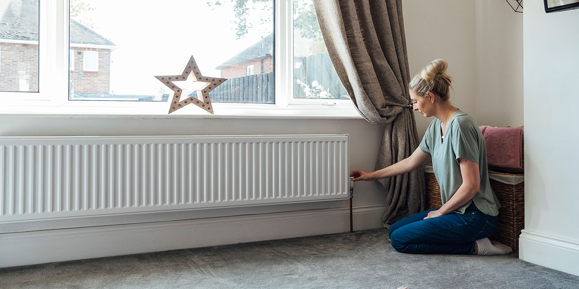 Woman changing temperature of radiator in her home