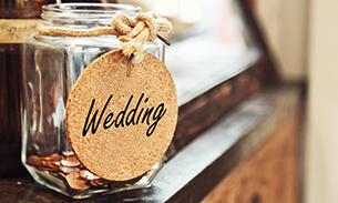 Jar filled with pennies with a sign wedding. 