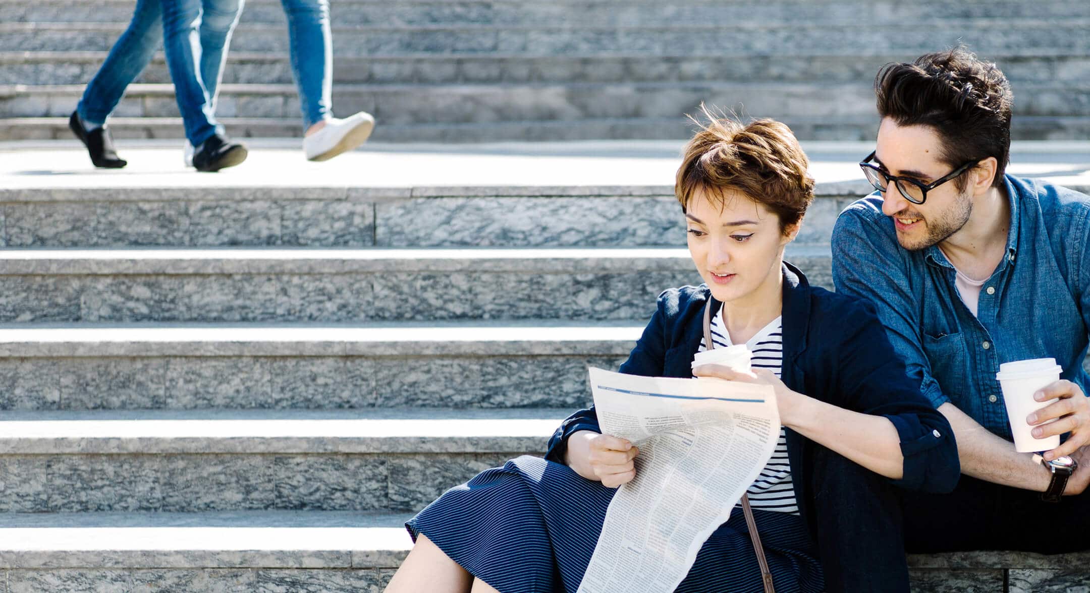 Happy couple sat on a step