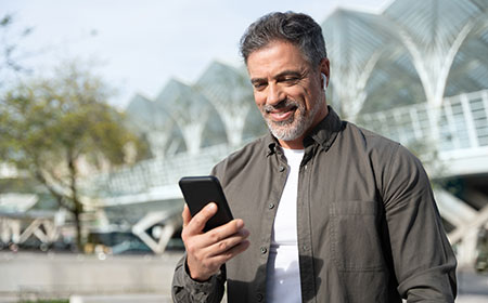 Man looking at phone smiling