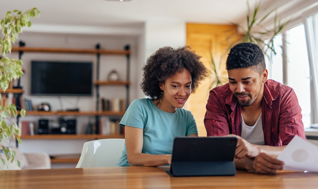 Couple sitting at desk on a laptop