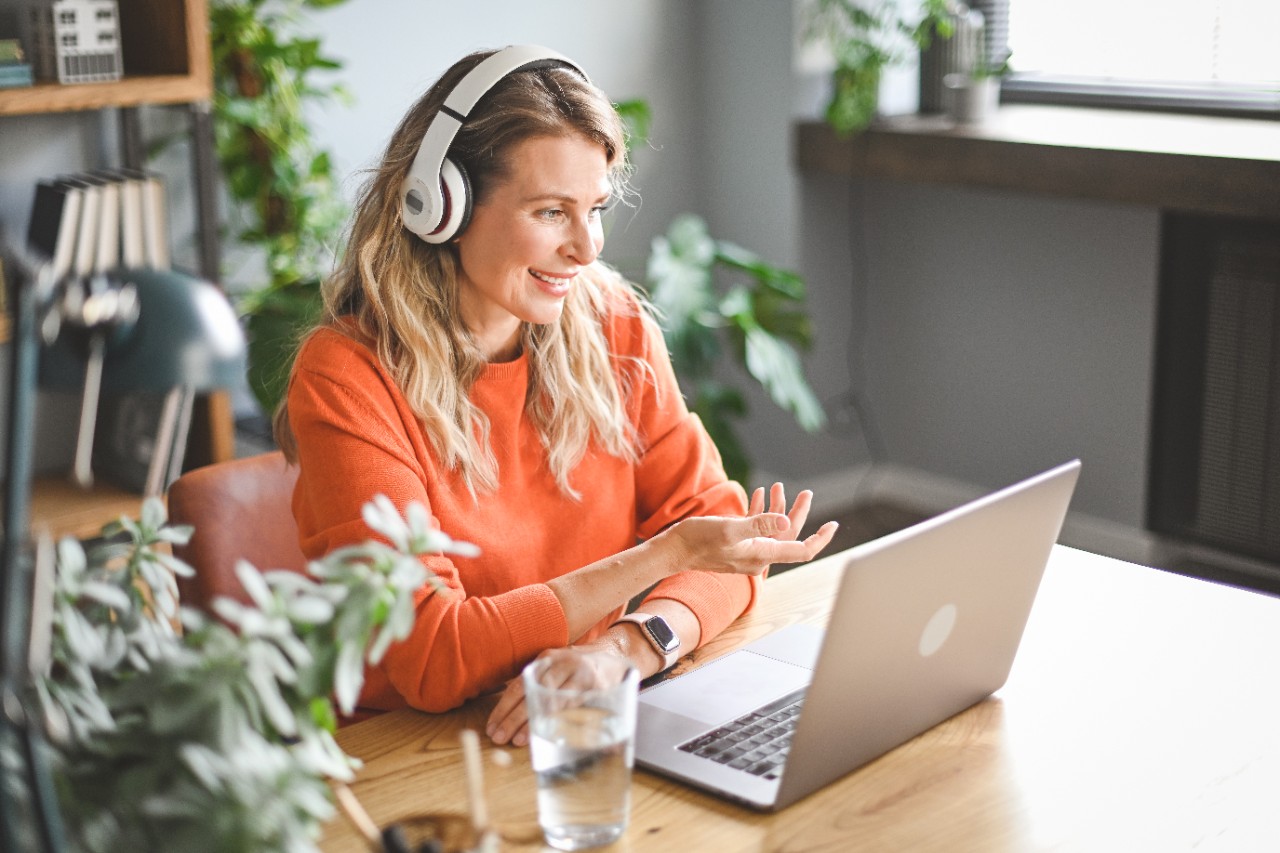 woman smiling on video call on laptop