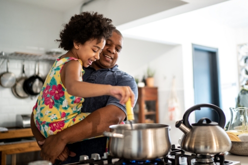 father and daughter cooking together